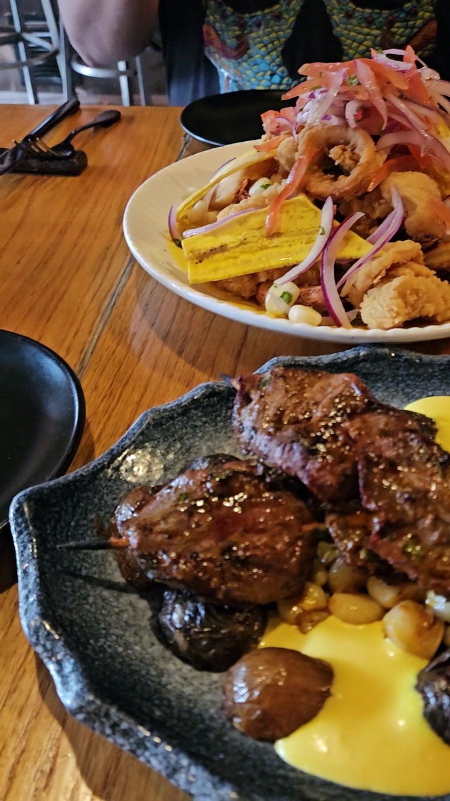 Grilled anticuchos and meats off the charcoal with golden potatoes and ají